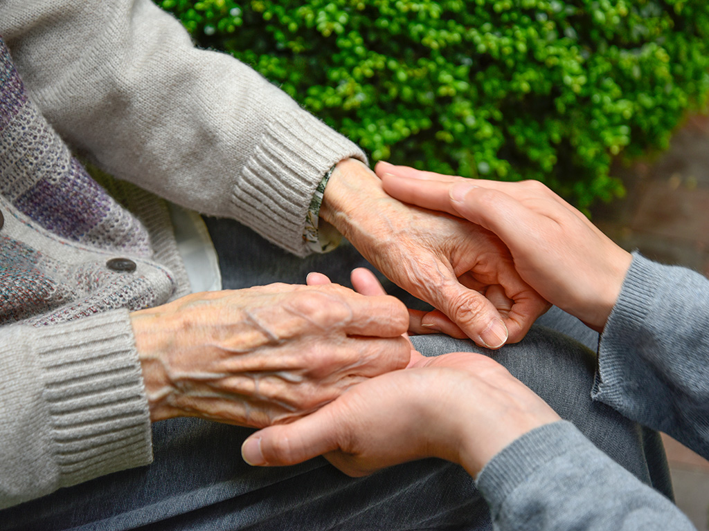 hands caring for dementia patient